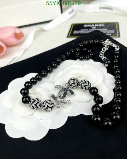 Black bead necklace with white flower and silver charm