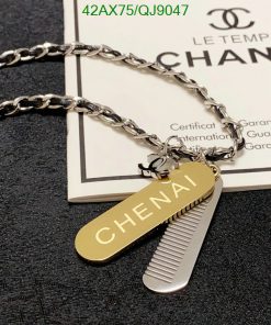 Designer silver chain with gold tag and comb pendants.