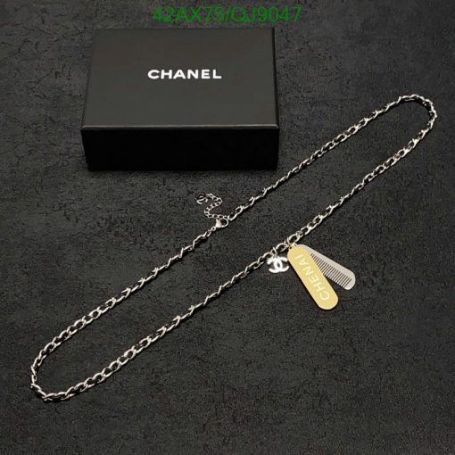 Chanel necklace with logo pendant on dark background.