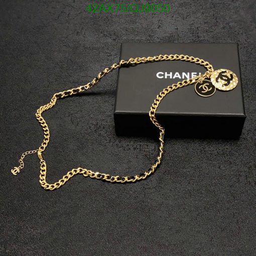 Gold chain necklace on black box.