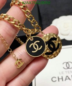 Gold chain bracelet with designer logo charms.