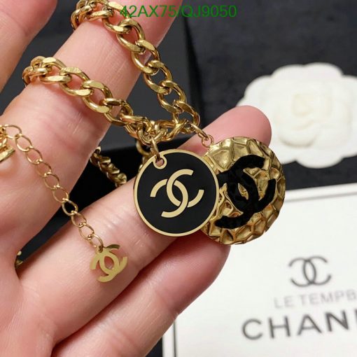 Gold chain bracelet with designer logo charms.