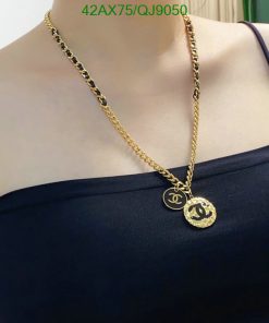 Gold chain necklace with pendant on mannequin.