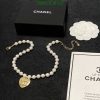 Chanel pearl necklace with logo pendant and packaging.