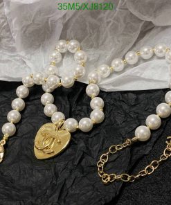 Pearl necklace and bracelet with gold heart pendant.