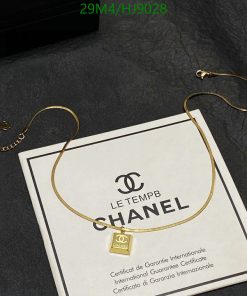 Gold necklace on Chanel certificate background.