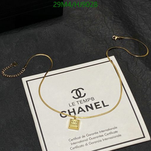 Gold necklace on Chanel certificate background.