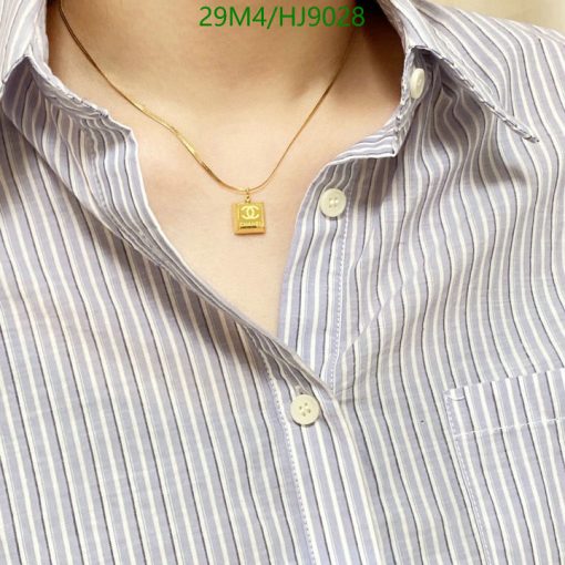 Striped shirt with pendant necklace.