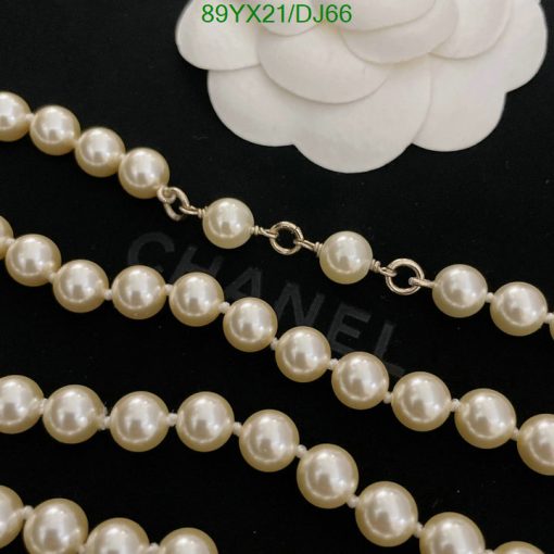 Elegant pearl necklace on black background.