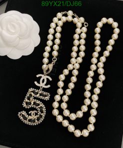 Pearl necklace with white flower and pendant.