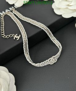 Elegant crystal-embellished designer necklace on black background.