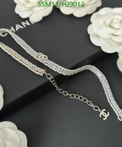 Diamond bracelet on black background with white flowers.