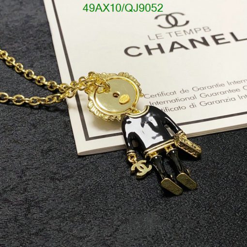 Chanel pendant necklace with certificate on dark background.