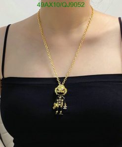 Woman wearing gold robot pendant necklace.