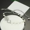 Elegant pearl bracelet with silver chain and charm detail.