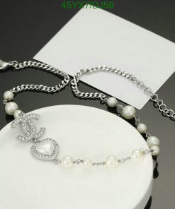 Elegant pearl bracelet with silver chain and charm detail.