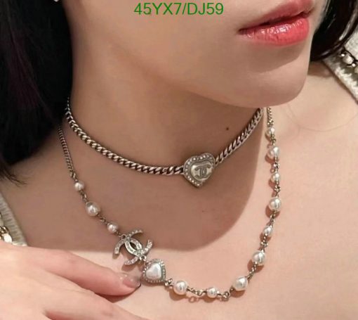 Woman wearing pearl and silver necklaces.