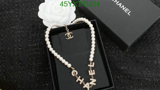 Chanel pearl necklace with logo letters on display box.