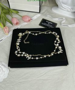 Pearl and crystal necklace on display with floral backdrop