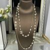 Elegant pearl and gold necklace display on bust.