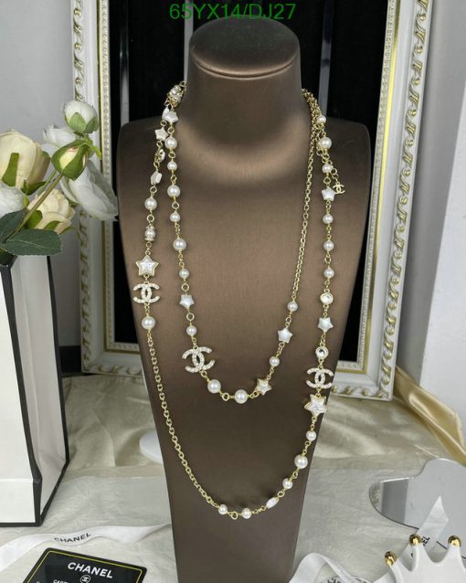 Elegant pearl and gold necklace display on bust.