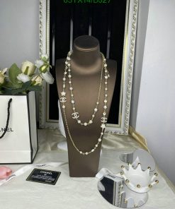 Elegant pearl and gold necklace display with accessories.