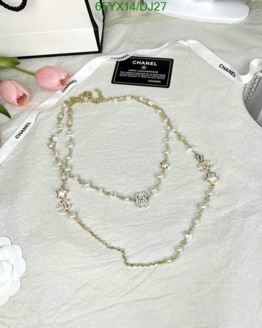 Elegant pearl necklace on textured surface with flowers.