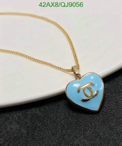 Heart-shaped pendant necklace on white surface.