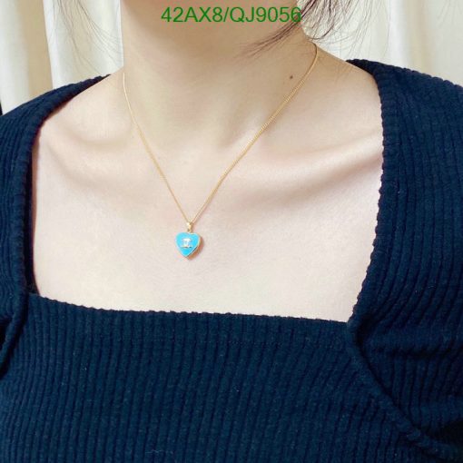 Woman wearing heart-shaped pendant necklace.