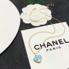 Gold necklace with pendant on branded card