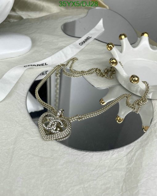 Designer necklace on display with branded packaging.