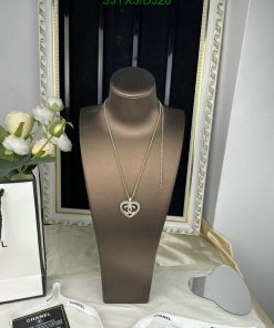 Designer heart pendant necklace display with flowers.