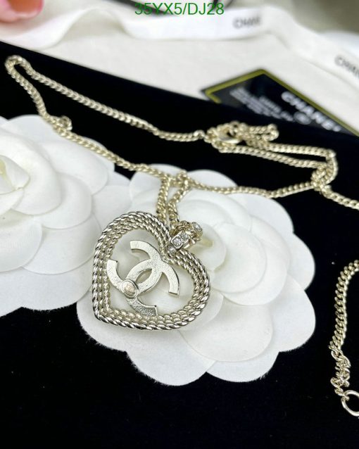 Silver heart pendant necklace on white petals.