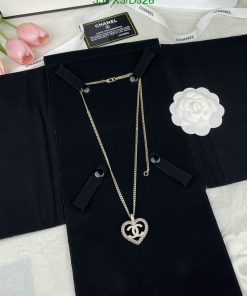 Designer necklace on black velvet with label and decorations.