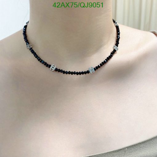 Black beaded choker necklace on woman's neck.