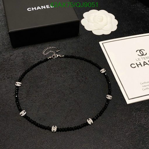 Designer black beaded necklace with logo and packaging.