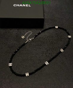 Black beaded necklace with white logos and box.