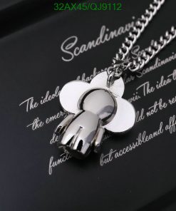 Silver flower pendant on chain with reflection.