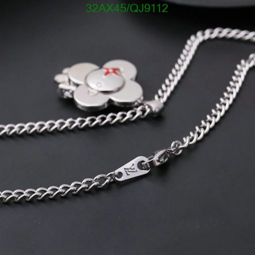 Silver flower pendant necklace on dark background.