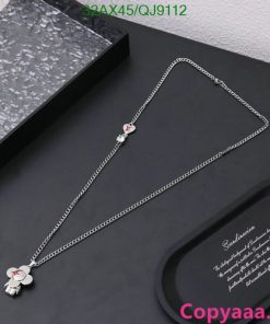 Elegant silver floral pendant necklace on black background.