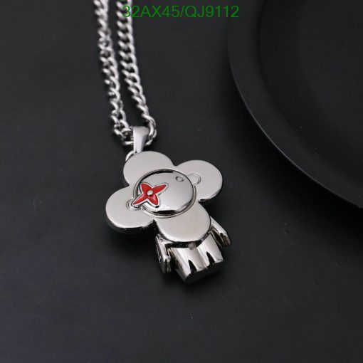 Silver teddy bear pendant with red bow detail.