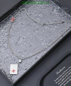 Silver necklace with red emblem pendant in box.