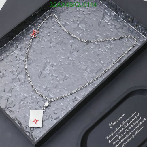 Silver necklace with red emblem pendant in box.