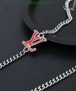 Silver chain necklace with red pendant.