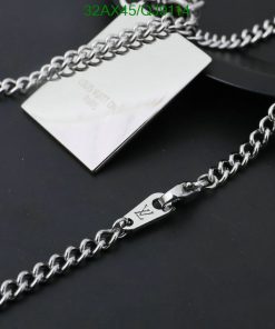 Silver designer chain necklace on black background.