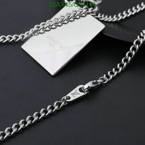 Silver designer chain necklace on black background.