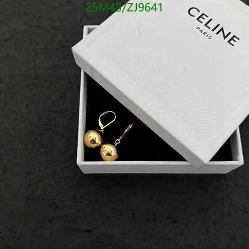 Gold earrings in box with brand name.