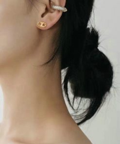 Woman with elegant earrings and updo hairstyle.