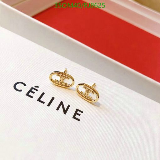 Gold designer logo earrings on display box