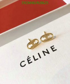 Gold designer logo earrings on white display.